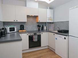 A kitchen with appliances and a sink at Havelock Hideaway in Windermere