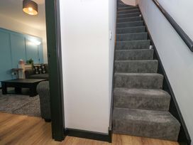A staircase leading to upper floor with adjacent living room at Havelock Hideaway in Windermere