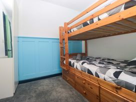 A bedroom with a bunk bed and storage drawers at Havelock Hideaway in Windermere