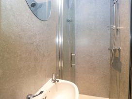 A bathroom with a shower and sink at Havelock Hideaway in Windermere