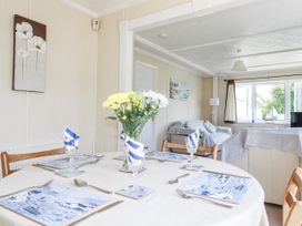 A dining room with a table set for meals at Lazy Days in St Merryn