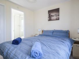 A bedroom with a bed and towels on it at Lazy Days St Merryn