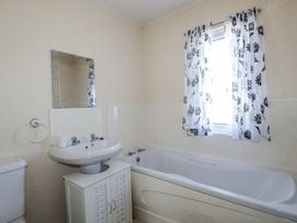 A bathroom with a bathtub, sink and toilet at Lazy Days in St Merryn