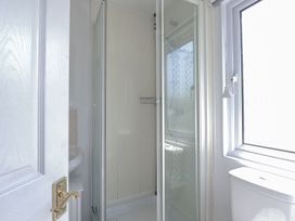A bathroom with a shower, toilet and sink at Lazy Days in St Merryn