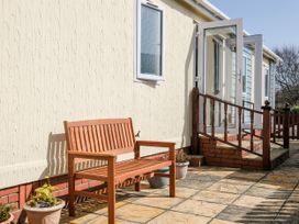 An outdoor area with a bench and steps at Lazy Days in St Merryn