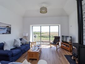 A living room with a sofa and television at West Burton Hemmel in Bamburgh