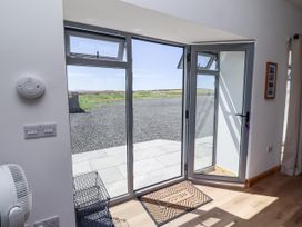 An entrance area with a door opening to a gravel path at West Burton Hemmel in Bamburgh