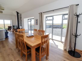 A living room with a dining table and chairs at West Burton Hemmel in Bamburgh