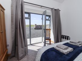 A bedroom with a bed and towels on it at West Burton Hemmel in Bamburgh