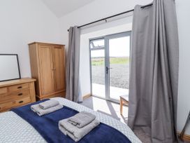A bedroom with a bed and wardrobe at West Burton Hemmel in Bamburgh