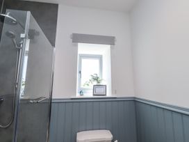 A bathroom with a shower and toilet at West Burton Hemmel in Bamburgh
