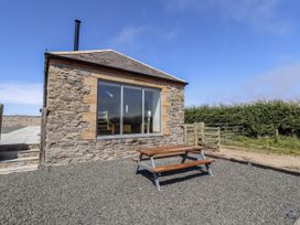 An outdoor view of a building with a picnic table at West Burton Hemmel Bamburgh