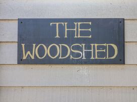 A sign with the text The Woodshed on a wooden wall at The Woodshed in Tendring near Weeley