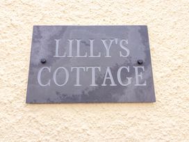 A nameplate displaying the text LILLY'S COTTAGE