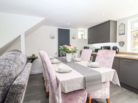 A dining room with a table set for dinner at Lilly's Cottage Dawlish