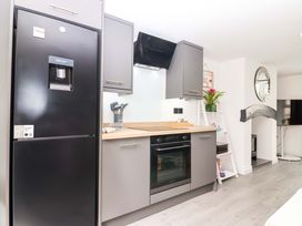A kitchen with a refrigerator and oven at Lilly's Cottage in Dawlish