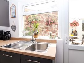A kitchen with a sink and kettle at Lilly's Cottage in Dawlish