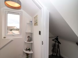 A hallway with a window and a shelf at Lilly's Cottage in Dawlish