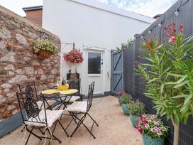 An outdoor area with a table and chairs at Lilly's Cottage Dawlish