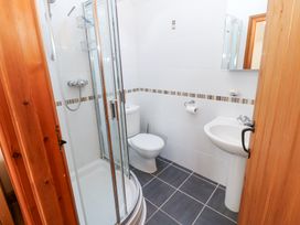 A bathroom with a shower enclosure toilet sink and mirror at Rayson Hall Barns in Ousby