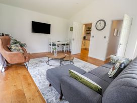 A living room with a sofa and coffee table at Mount House Bryniau near Dyserth