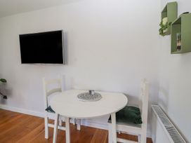 A dining room with a table and chairs at Mount House Bryniau near Dyserth