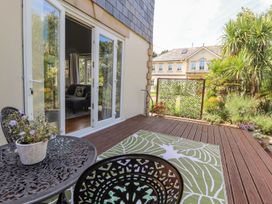 An outdoor patio with a table and chairs at Mount House Bryniau near Dyserth