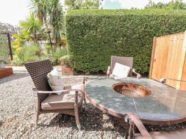 A garden with outdoor furniture and a fire pit at Mount House Bryniau near Dyserth