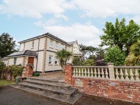 A house with a garden and steps at Mount House Bryniau near Dyserth