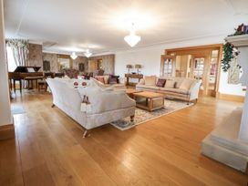 A living room with sofas and a piano at Mount House Bryniau near Dyserth
