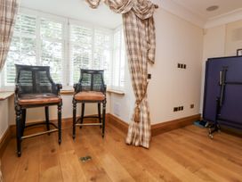 A snug with bar stools and window at Mount House Bryniau near Dyserth
