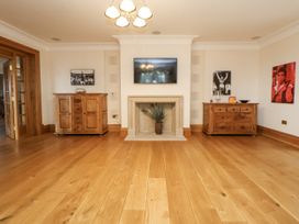 A living room with a fireplace and television at Mount House in Bryniau near Dyserth