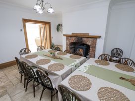 A dining room with tables arranged at Mount House Bryniau near Dyserth