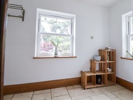 A room with a window and a wooden shelf at Mount House Bryniau near Dyserth