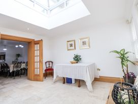 A dining room with a table and chairs at Mount House in Bryniau near Dyserth