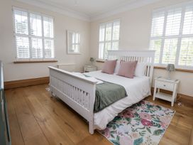 A bedroom with a bed and nightstand at Mount House Bryniau near Dyserth