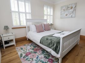 A bedroom with a bed and side tables at Mount House in Bryniau near Dyserth