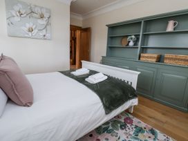 A bedroom with a bed and shelf at Mount House Bryniau near Dyserth