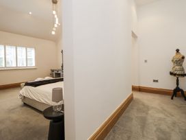 A bedroom with a bed and a mannequin at Mount House in Bryniau near Dyserth