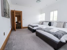 A bedroom with two beds and a door at Mount House Bryniau near Dyserth