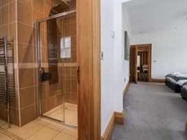 A bathroom with a shower and towel radiator at Mount House in Bryniau near Dyserth