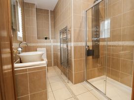 A bathroom with a bathtub, toilet, shower, and sink at Mount House in Bryniau near Dyserth
