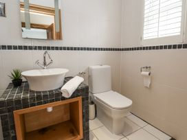 A bathroom with a sink and toilet at Mount House Bryniau near Dyserth