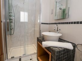 A bathroom with a shower and a sink at Mount House Bryniau near Dyserth