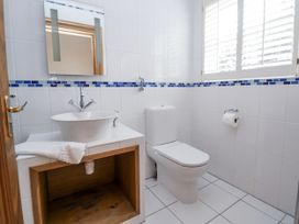 A bathroom with a sink and toilet at Mount House in Bryniau near Dyserth