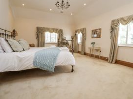 A bedroom with a bed and bedside lamp at Mount House in Bryniau near Dyserth