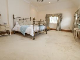 A bedroom with a bed and bedside table at Mount House in Bryniau near Dyserth