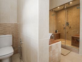 A bathroom with a shower and toilet at Mount House Bryniau near Dyserth