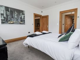 A bedroom with a bed and towels at Mount House Bryniau near Dyserth