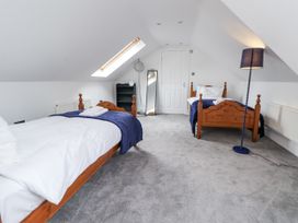 A bedroom with two beds and a mirror at Mount House Bryniau near Dyserth